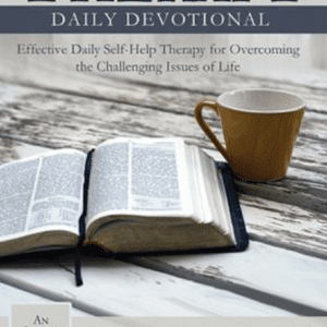 A book sitting on top of a table next to a cup.